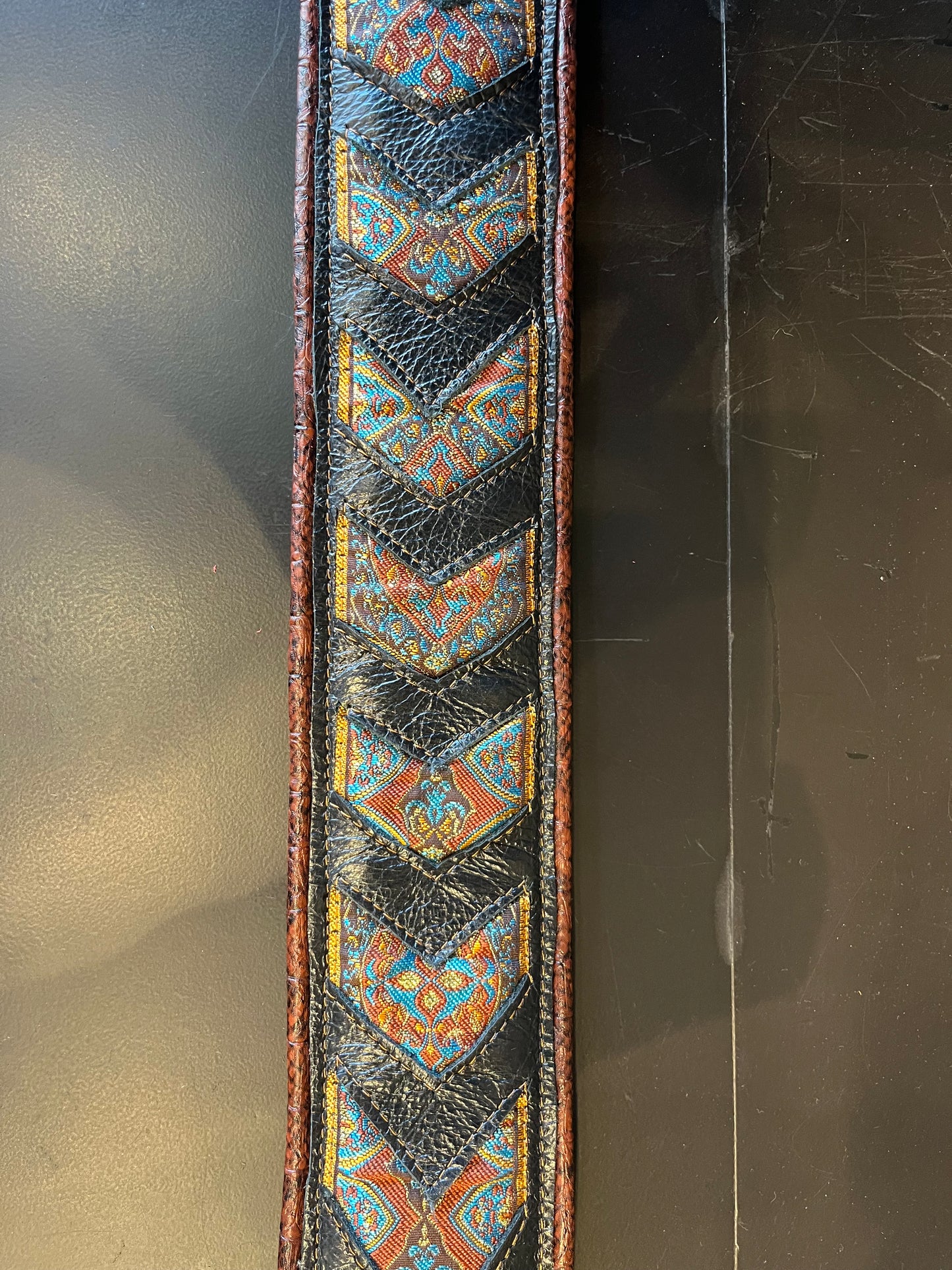 Ferrini Hand Made Leather Guitar strap Black with woven Indian trim and alli-faux piping